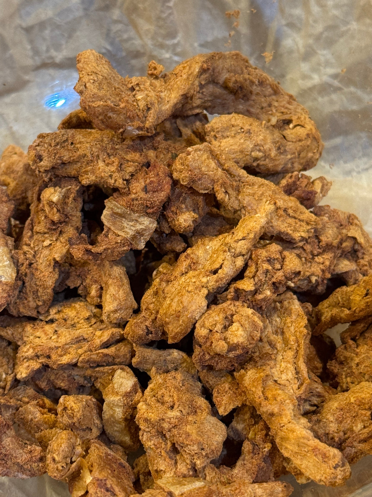 Close up of taco style freeze dried protein strips that look light and crunchy