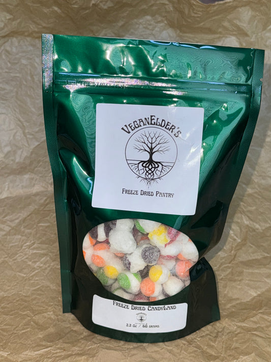 Retail bag of sour freeze dried spheres of candy in a green mylar bag with an oval window showing the candy inside. The Logo on the bag says Veganelder's Freeze Dried Candy.