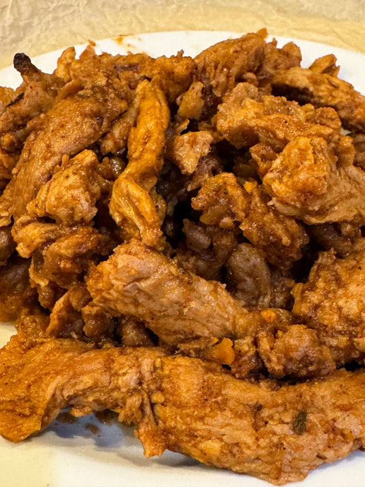 Close up barbecue Protein strips rehydrated from freeze dried. There is reddish sauce clinging to the pieces looking delicious