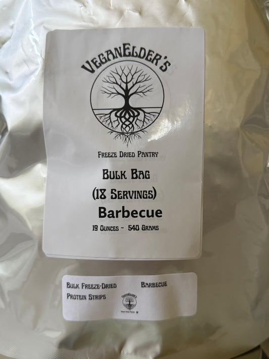 A large white bag of Veganelder's 18 servings Bulk Freeze-Dried Barbecue protein strips, with a smaller matching label placed in front on a white background.