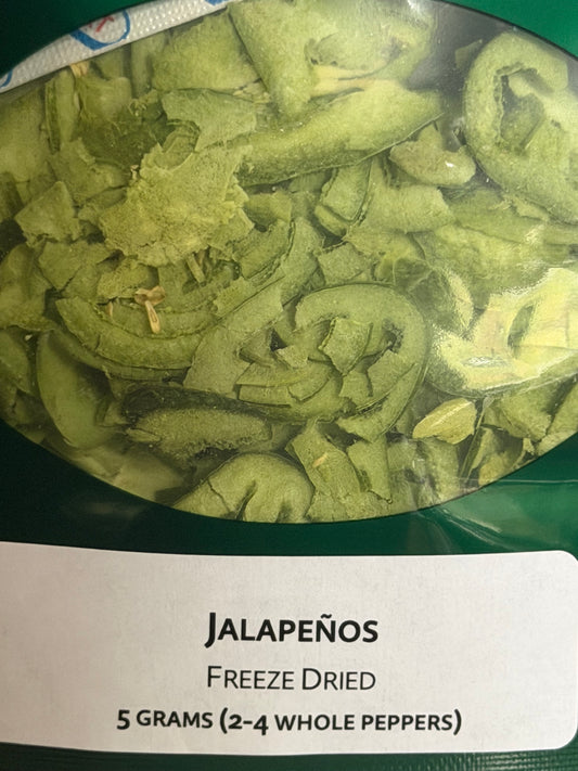 Transparent window of freeze dried alapeño pouch  containing slices of jalapeños with a label stating 5 grams containing 2 to 4 peppers.