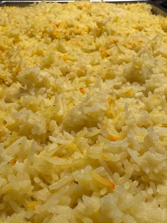 Saffron Basmati Rice in a freeze drying pan before its freezer dried.  You can see red strands of saffron throughout the yellow colored rice