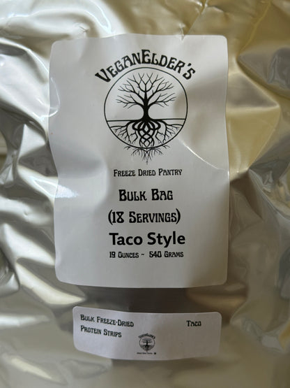 A bulk bag of VeganeLder's Taco Style freeze dried protein strips, 19 ounces (540 grams), shown in a silver foil pouch with a white paper label.