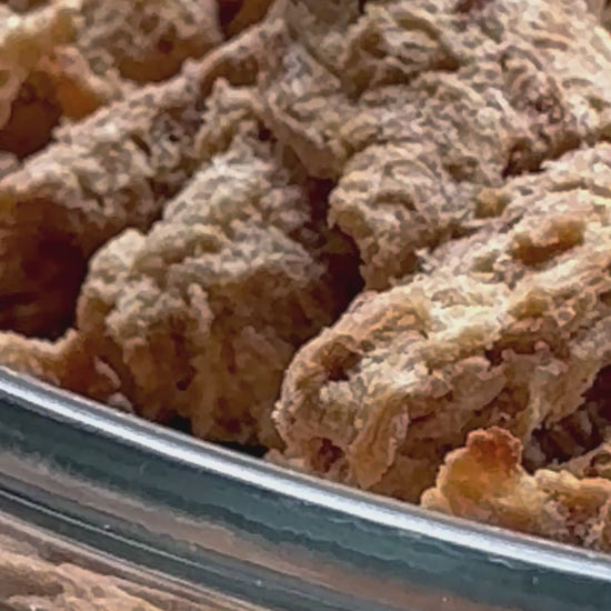 Video of plant protein strips that have been freeze dried in a bowl.